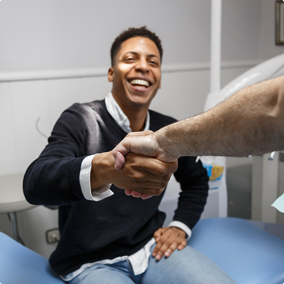 Dental patient shaking his dentist's hand