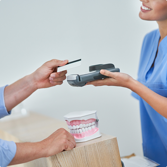 Holding out credit card reader for patient