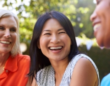 Three women sitting and laughing