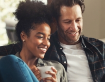 Man and woman sitting on couch together