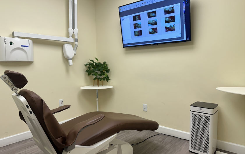 Dental chair facing an overhead monitor