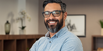 Bearded man with glasses smiling