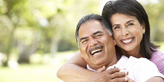 Woman hugging man from behind outside