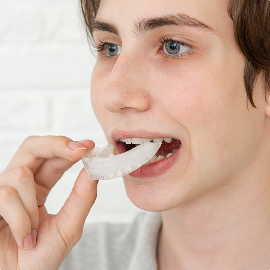 Boy opening mouth to put in nightguard