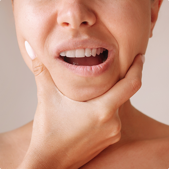 Close up of woman with TMJ disorder in Phoenix rubbing jaw