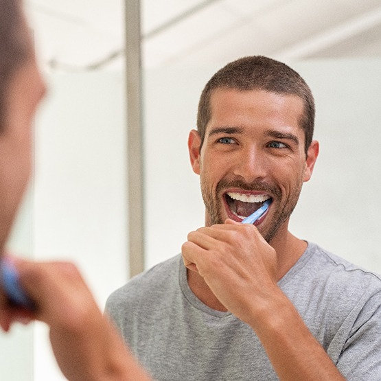 Patient in Phoenix brushing their teeth to maintain their teeth whitening